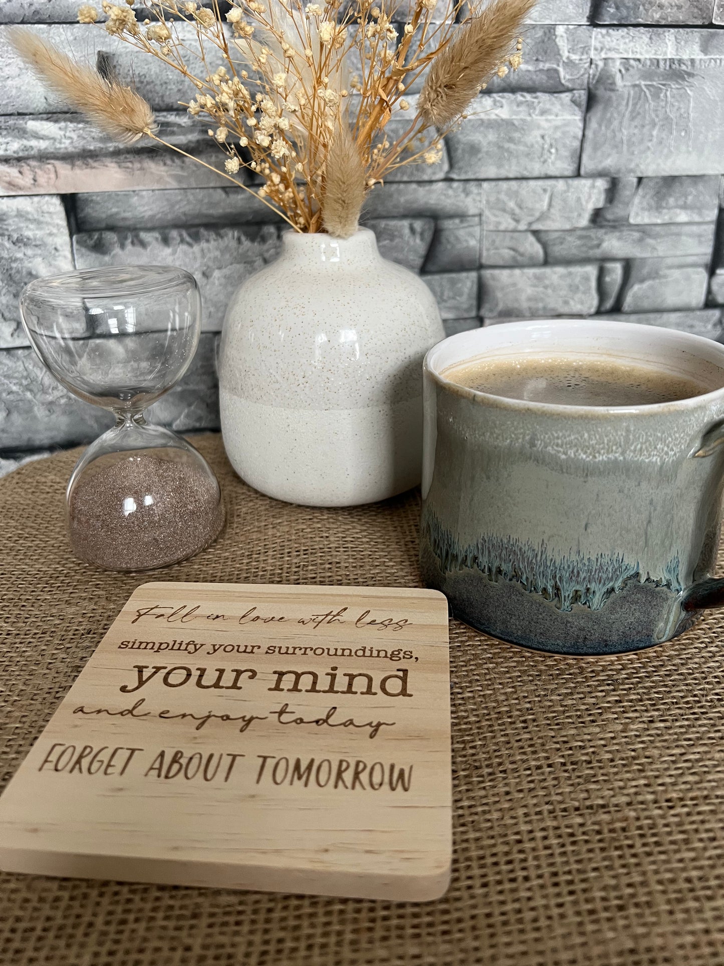 Engraved wooden coaster “Fall in love with less…”