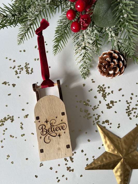 Believe engraved wooden sleigh tree decoration