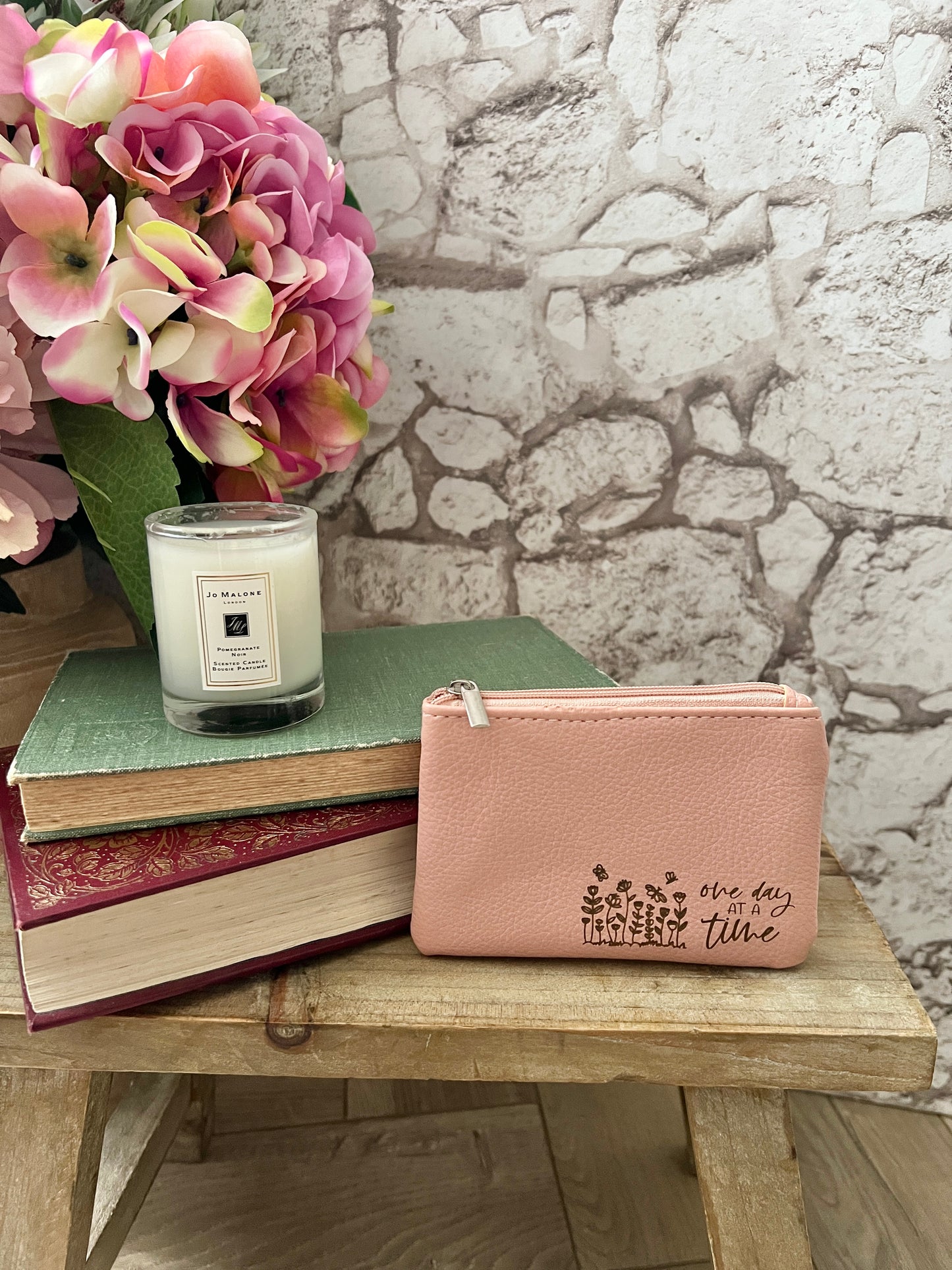 Pink coin purse with flowers and text "one day at a time"